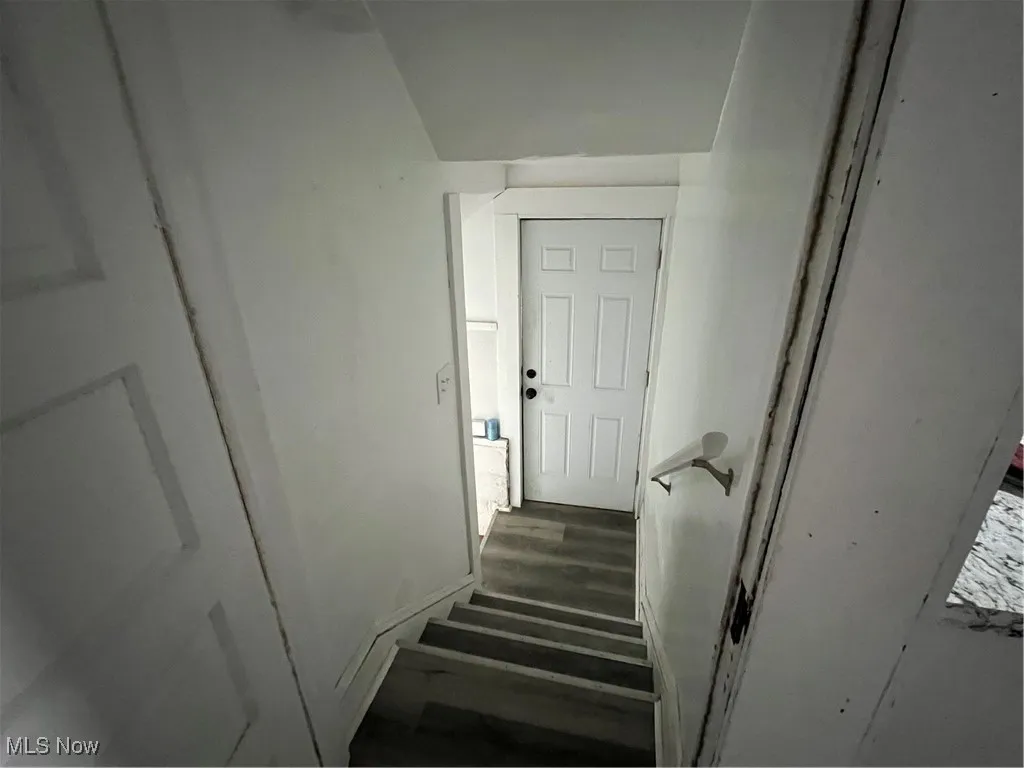 Stairs featuring wood finished floors