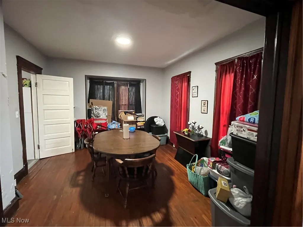 Dining area with dark wood-style flooring