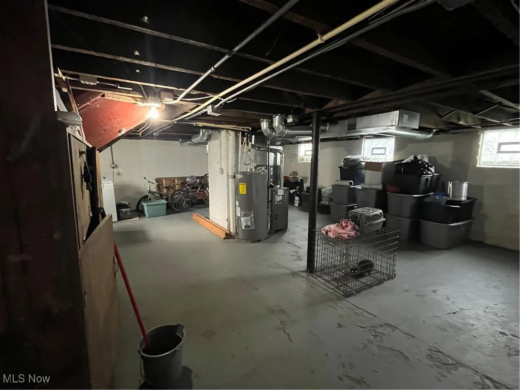 Below grade area featuring water heater