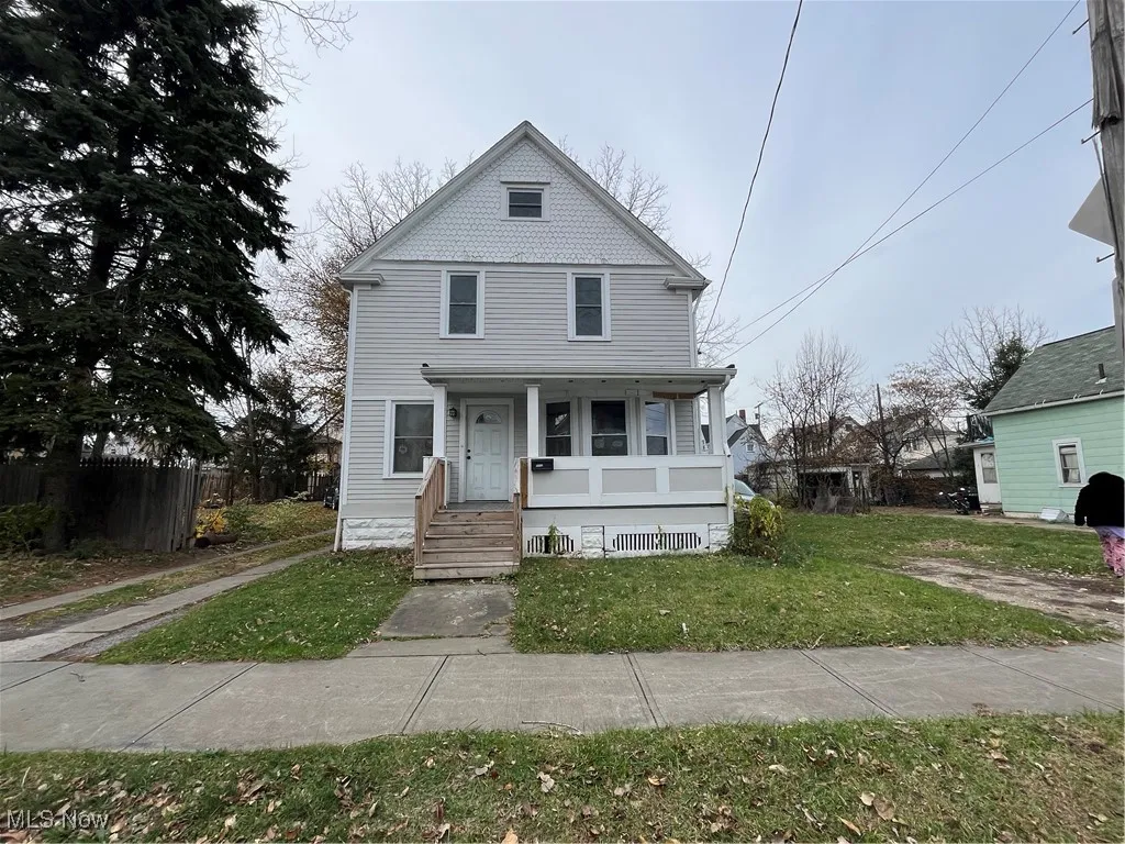 View of front of home with a porch and a front lawn