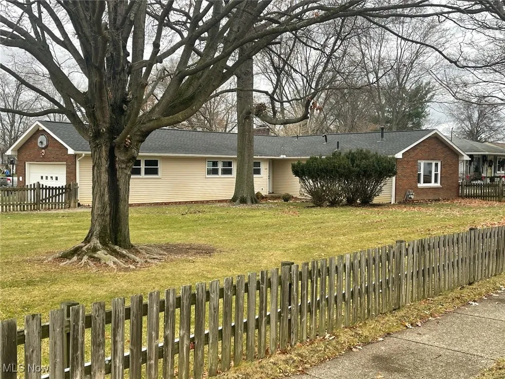 Ranch-style house featuring a garage and brick siding