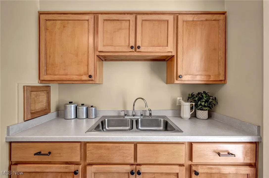 Kitchen featuring light countertops and light brown cabinets