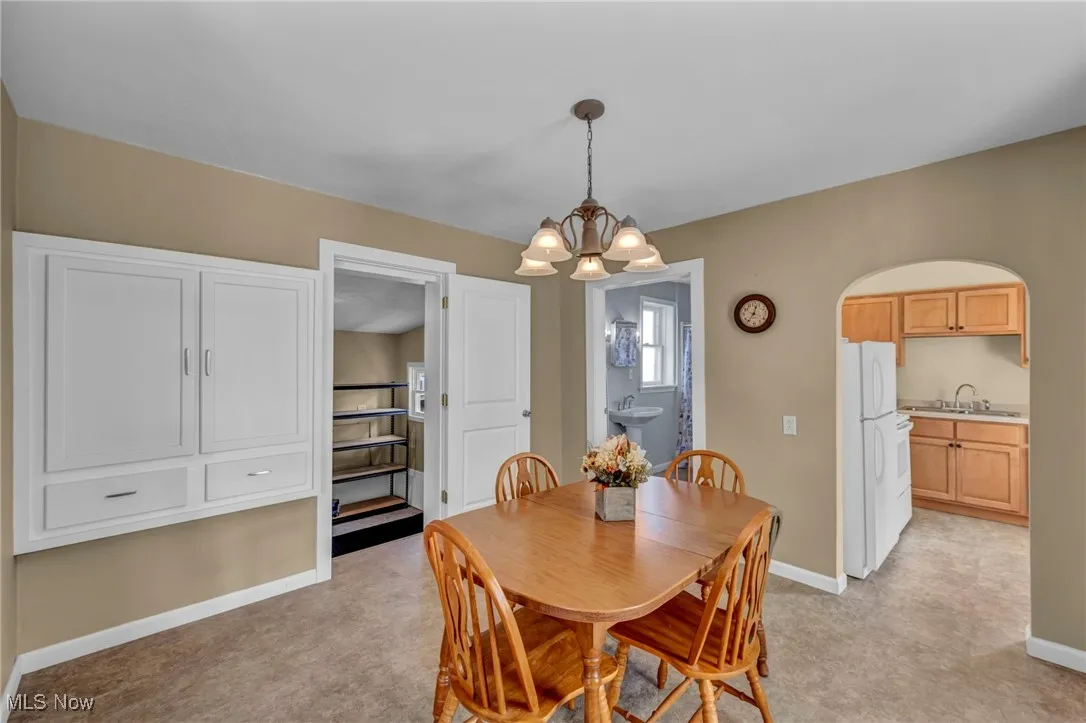Dining room featuring a chandelier and arched walkways