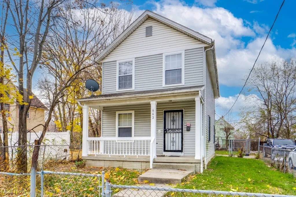 View of front of home featuring a fenced front yard and covered porch