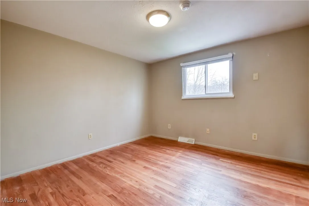 Spare room with light wood-style flooring and baseboards