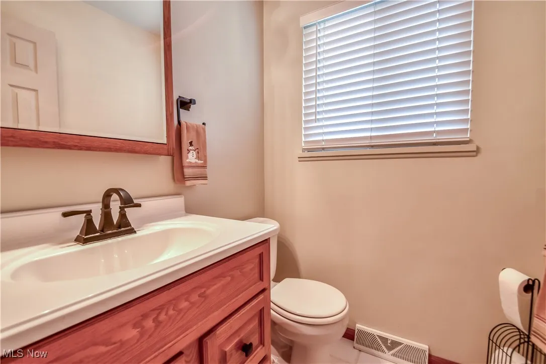 Half bath with vanity and toilet