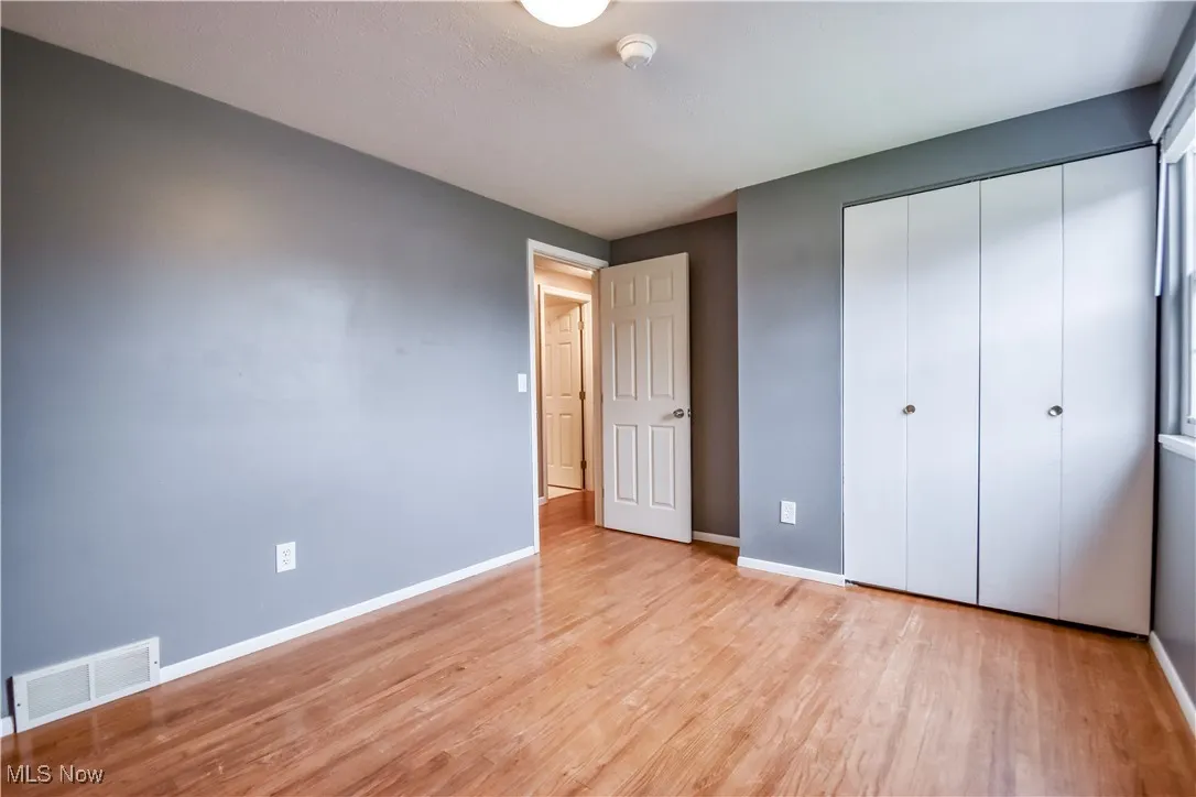 Unfurnished bedroom featuring a closet and light wood-style floors