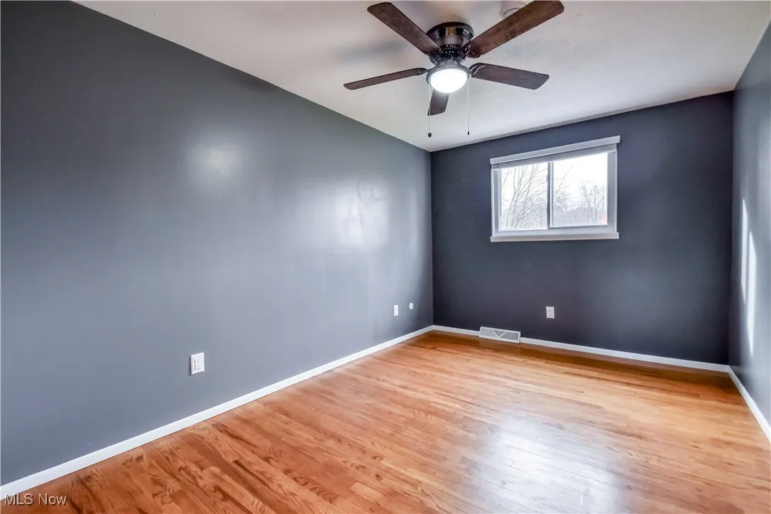 Unfurnished room featuring light wood-style flooring and ceiling fan