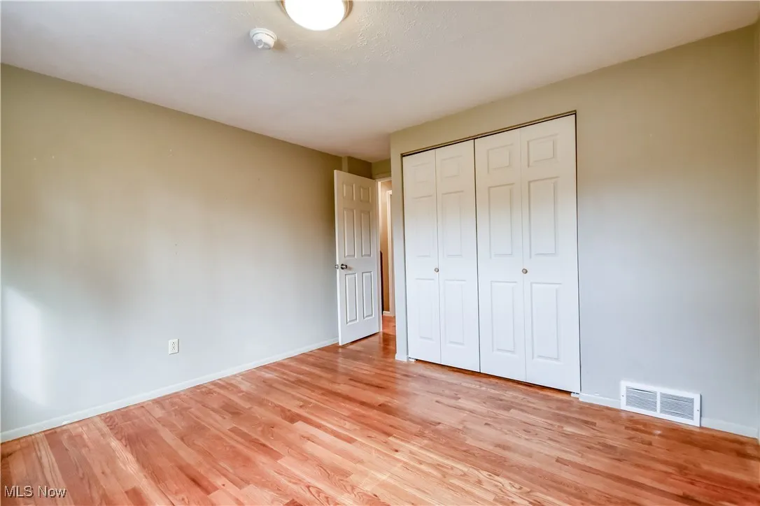 Unfurnished bedroom featuring a closet and light wood-type flooring