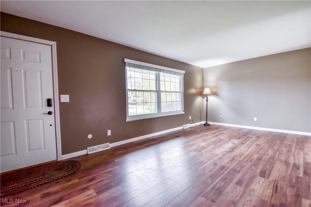 Foyer entrance featuring baseboards and wood finished floors