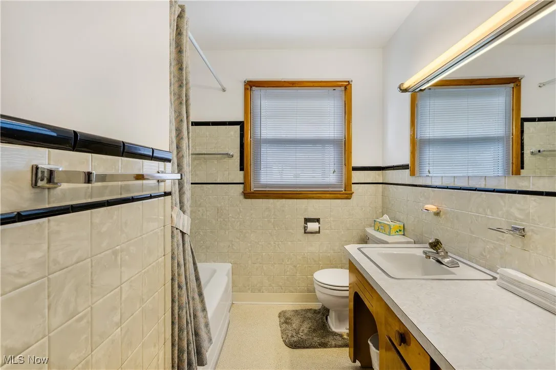 Full bath with vanity, shower / tub combo