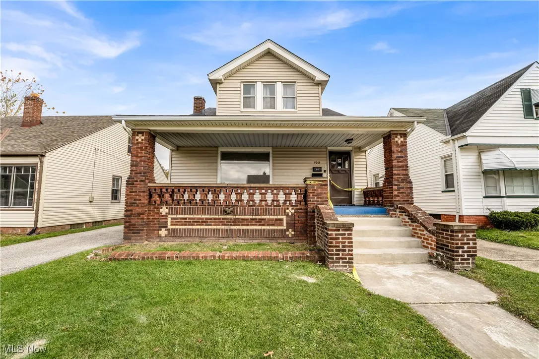 View of front of home featuring covered porch and a front lawn