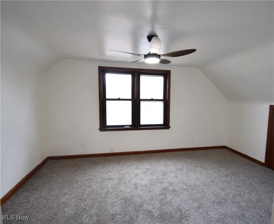 Bedroom with vaulted ceiling and carpet flooring