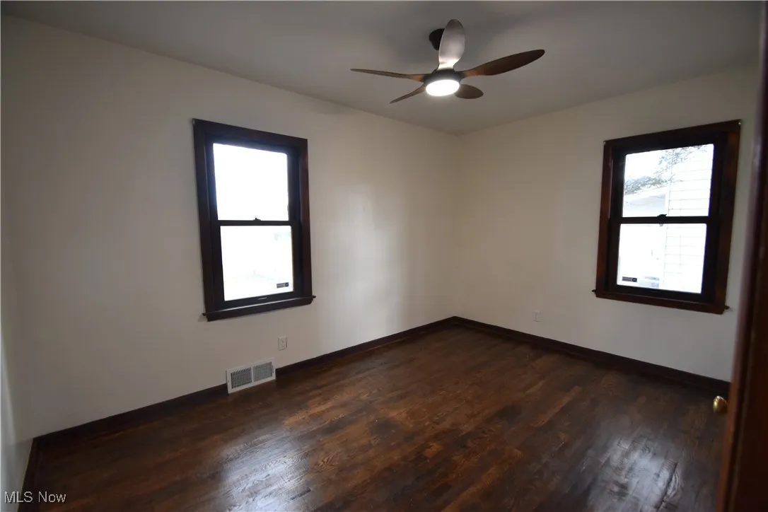 Bedroom featuring dark wood-style flooring and ceiling fan