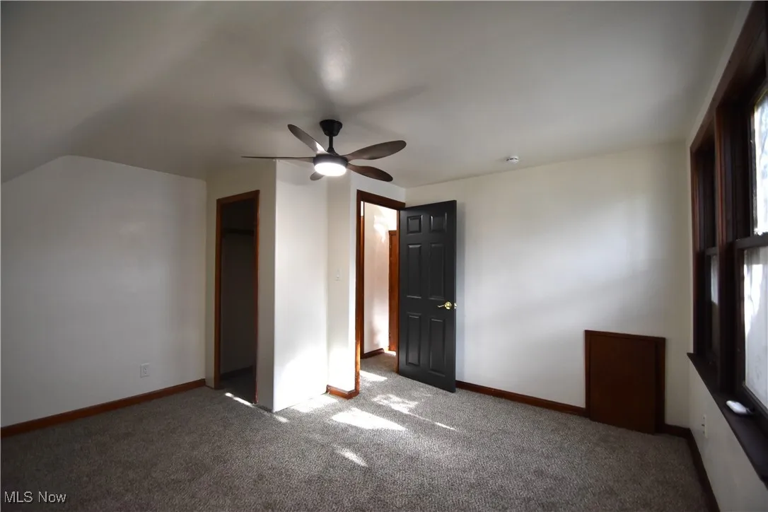 Unfurnished bedroom with carpet floors, ceiling fan, and a closet