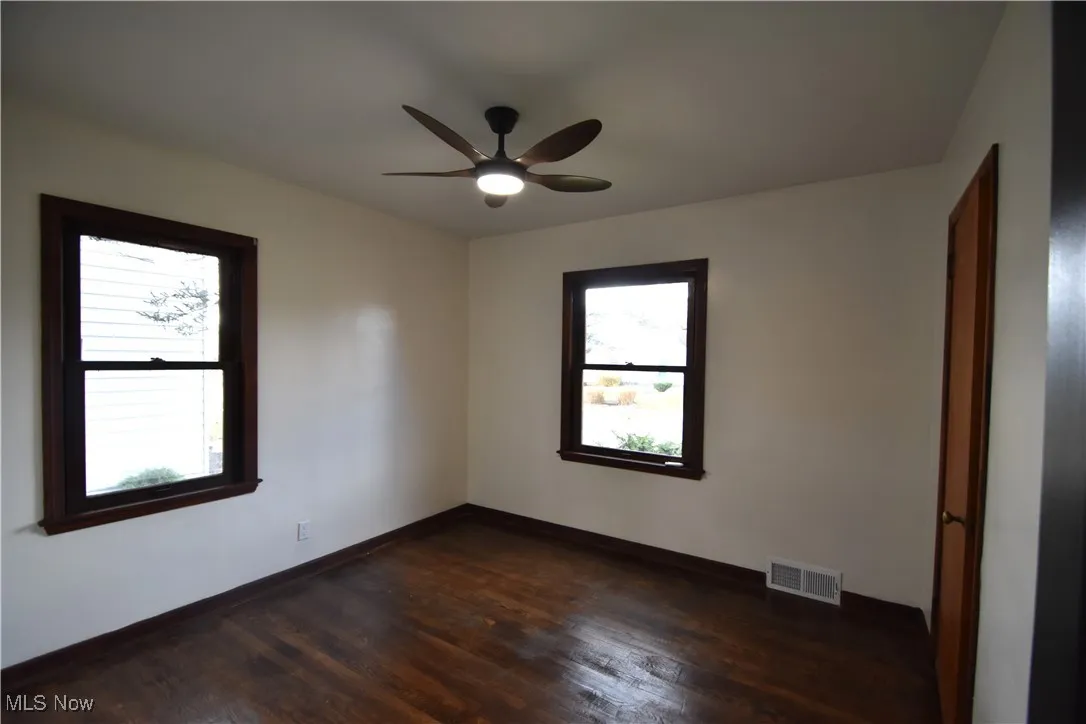 Bedroom featuring ceiling fan and dark wood-style floors