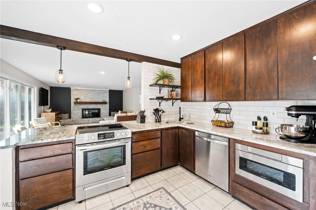 Modern kitchen with sleek cabinetry, ample storage, featuring a drawer mircrowave