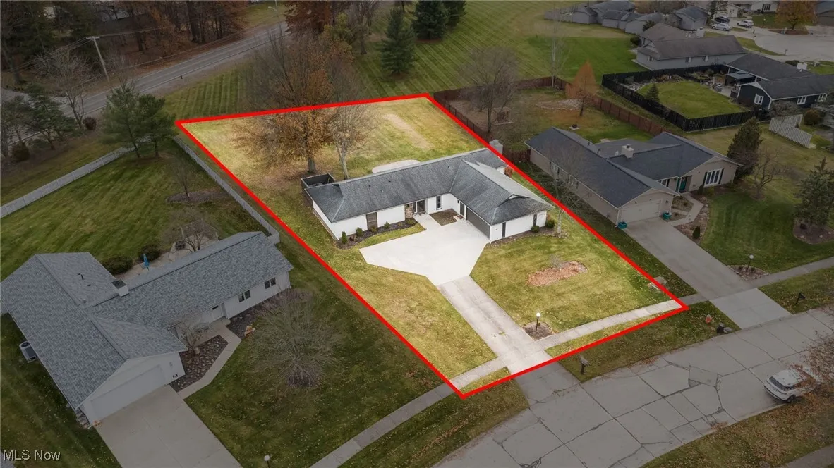 Aerial view of residential area with property parcel outlined