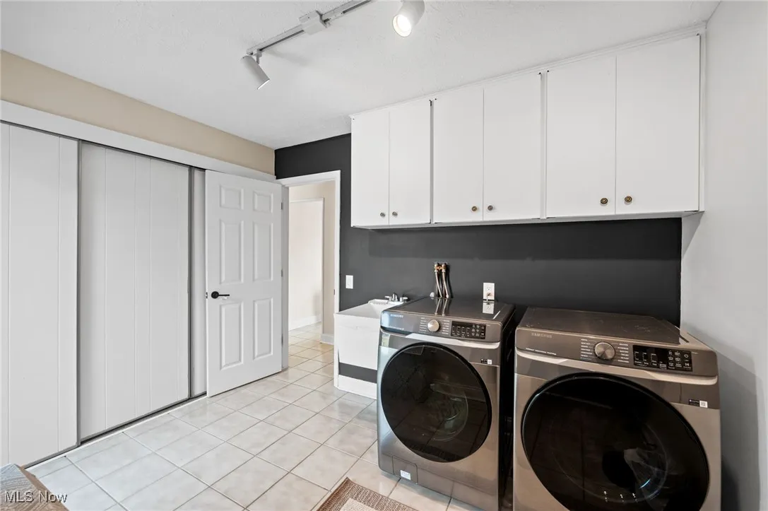 NEW washer/dryer! Cabinets for stoarge and utility sink.