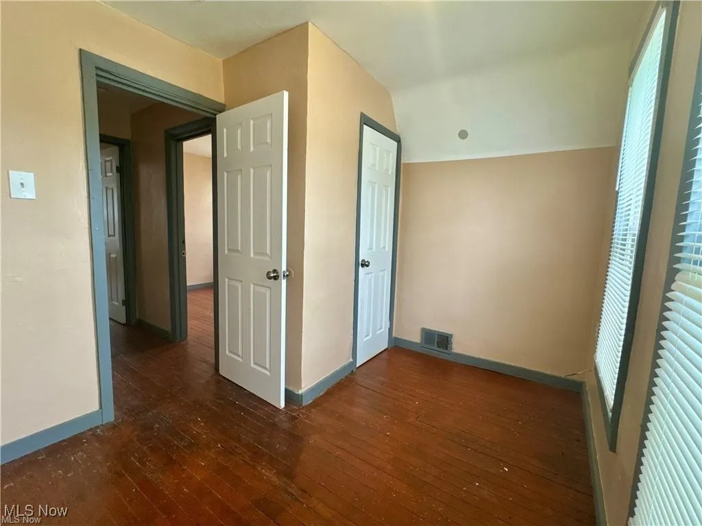Bedroom with a closet and wood flooring