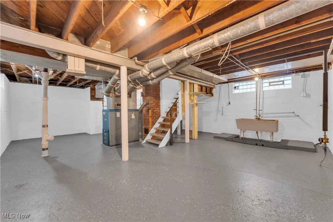 Basement with stairs and heating unit
