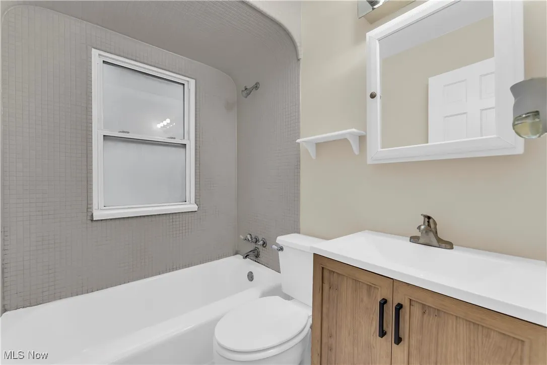 Bathroom with shower / washtub combination and vanity