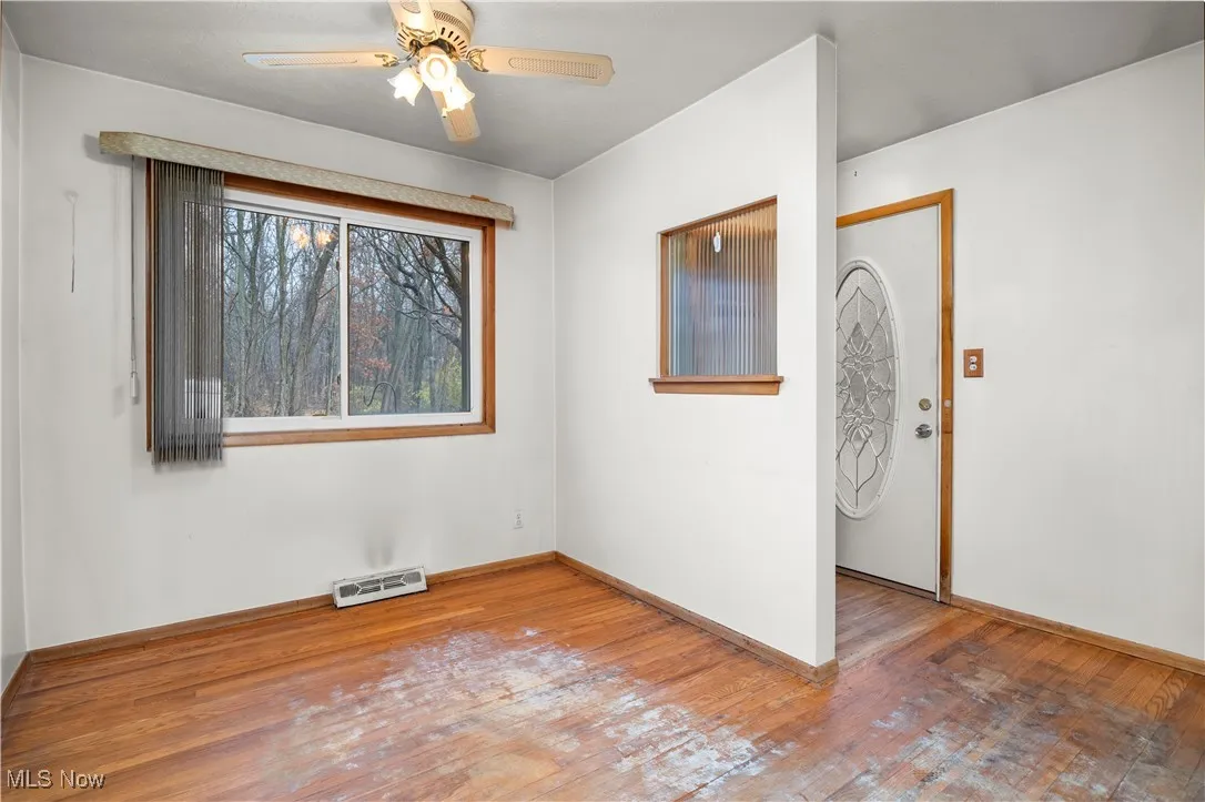Unfurnished bedroom with hardwood / wood-style floors and ceiling fan