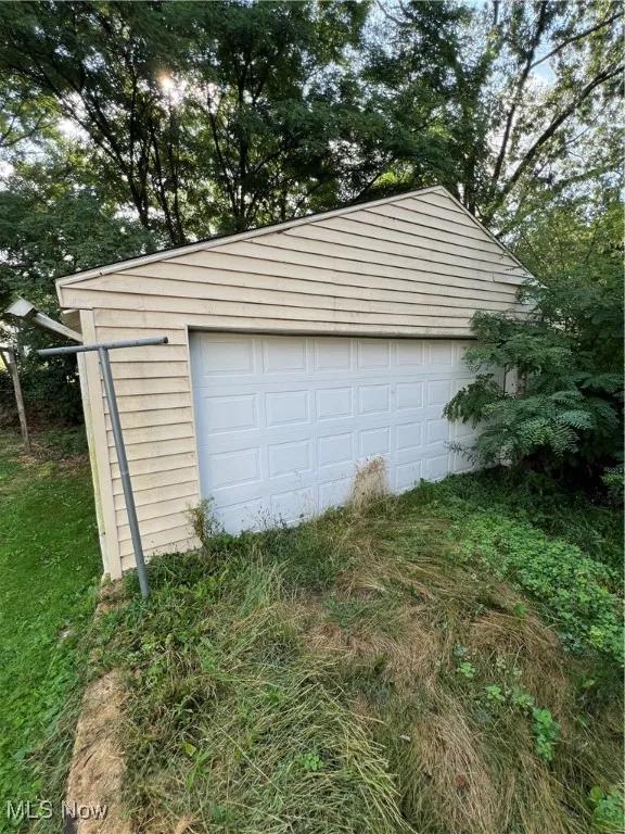 Garage with view of wooded area