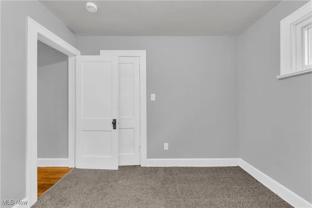 Unfurnished bedroom featuring carpet floors and baseboards
