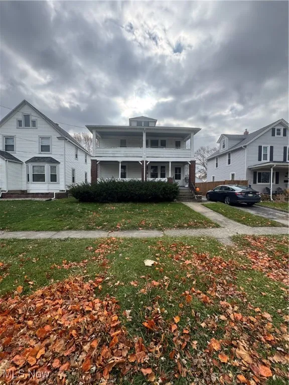 Traditional style home with a front yard and a porch
