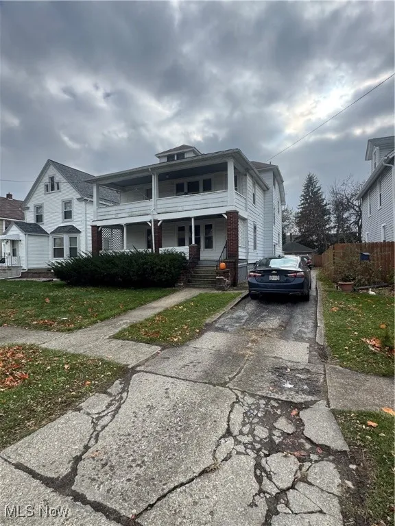 American foursquare style home featuring a porch