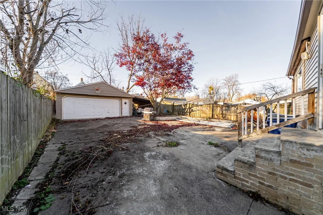 Fenced backyard with an outbuilding