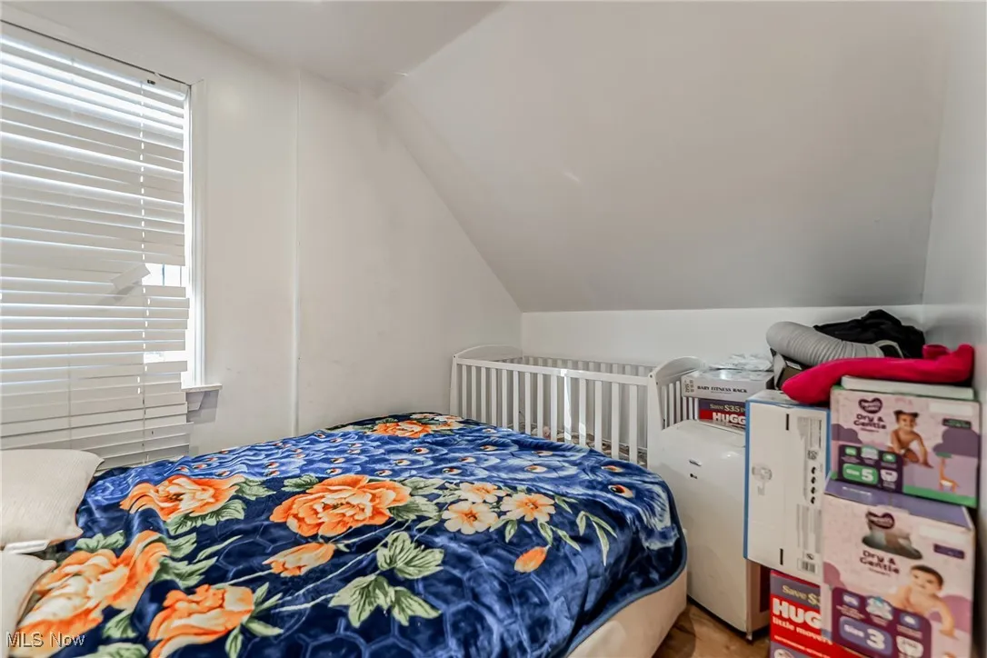 Bedroom featuring vaulted ceiling