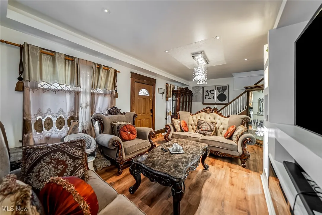 Living area featuring wood finished floors, stairs, and recessed lighting