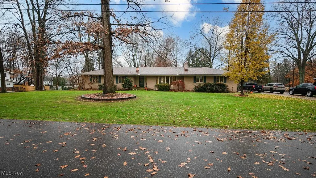 View of front of house with a front yard and a chimney