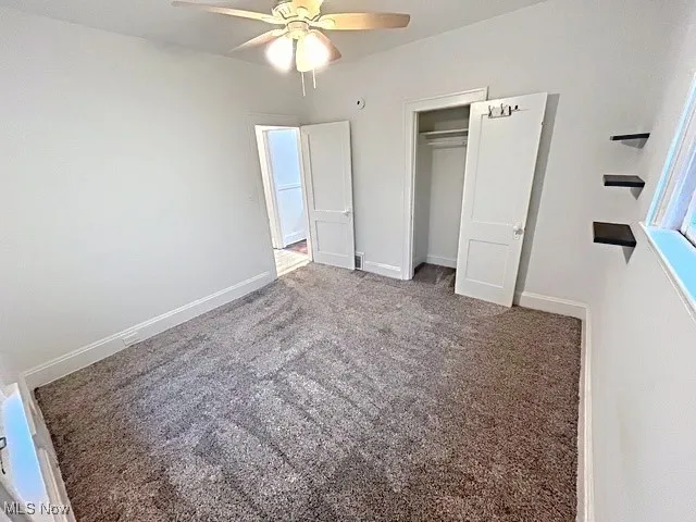 Unfurnished bedroom featuring carpet flooring, a closet, and ceiling​​‌​​​​‌​​‌‌​‌‌​​​‌‌​‌​‌​‌​​​‌​​ fan