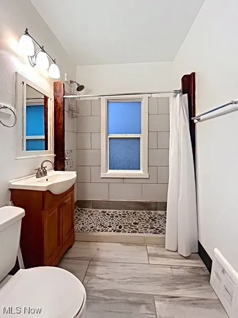 Full bath with vanity and a stall shower