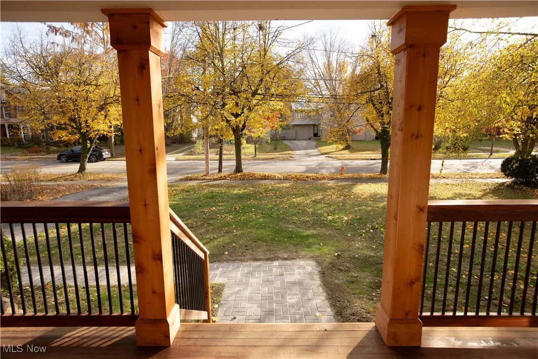 View of grassy yard with a porch