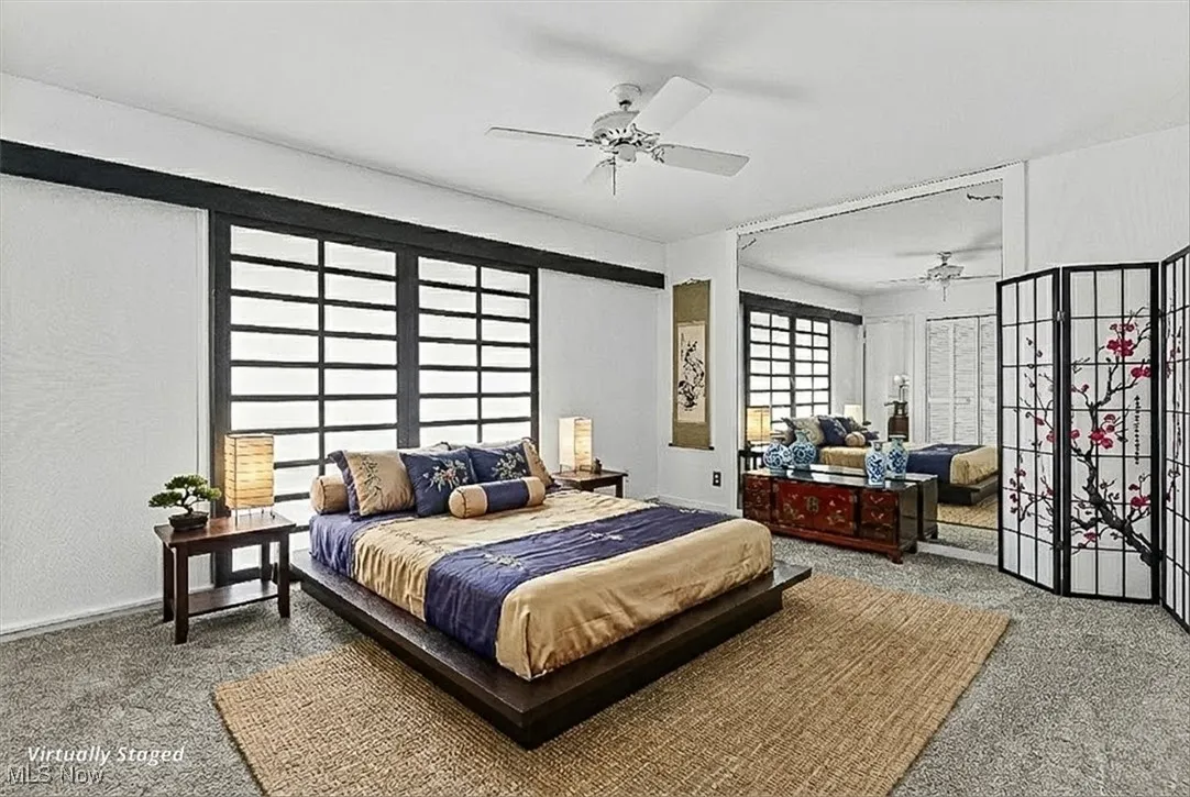 Bedroom with carpet floors and a ceiling fan
