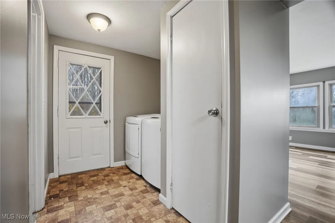 Washroom with healthy amount of natural light and washer and clothes dryer