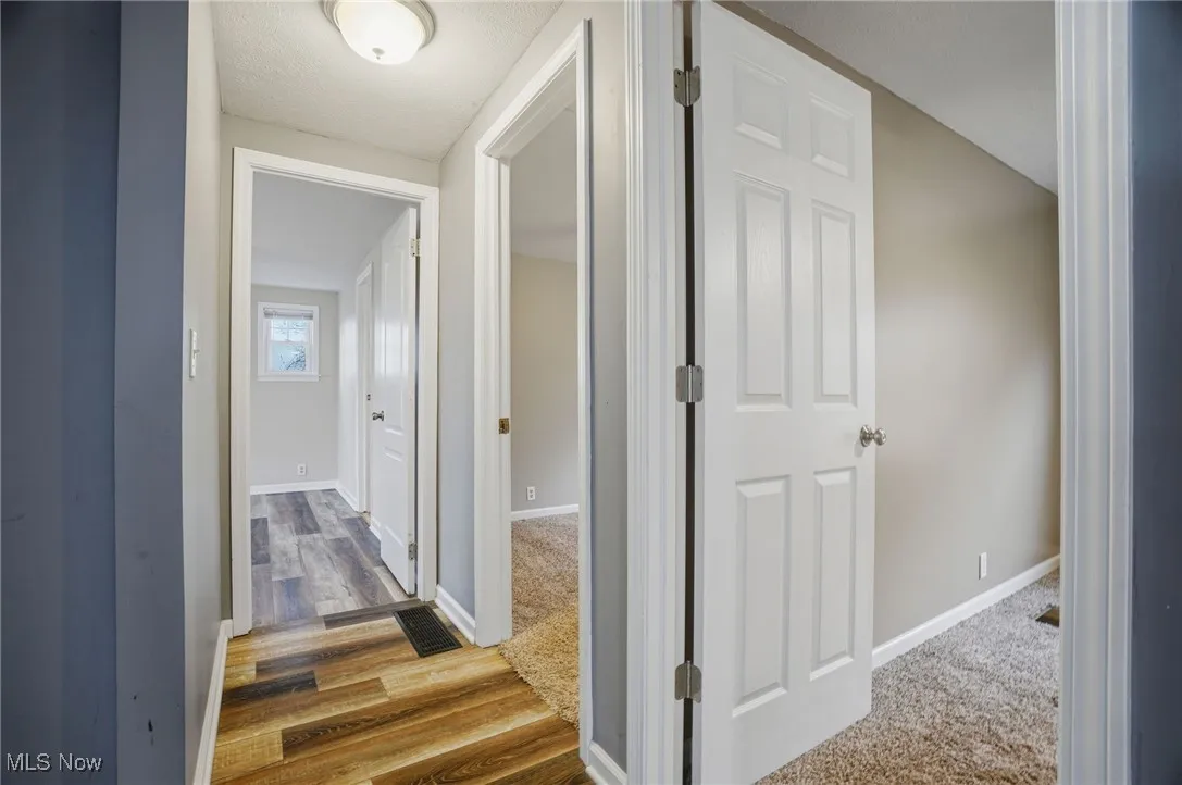 Hall featuring baseboards and light wood-style floors