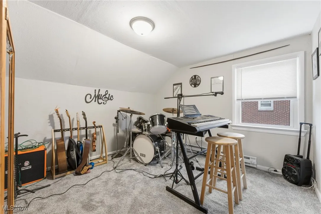 Playroom with carpet and lofted ceiling