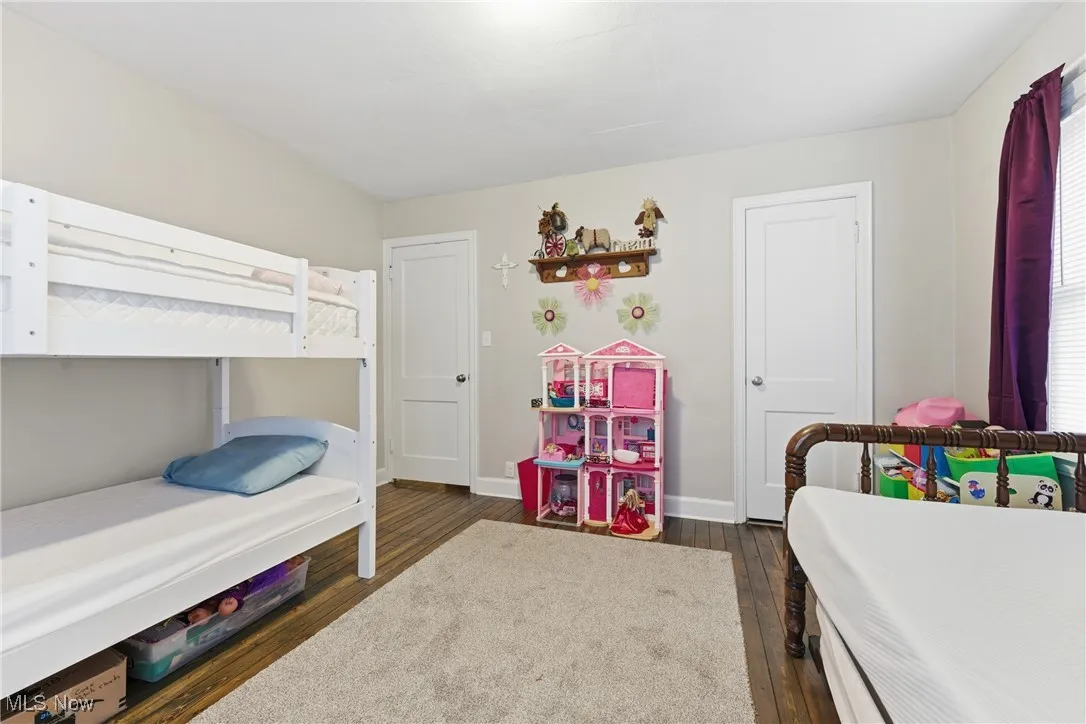 Bedroom featuring baseboards and dark wood finished floors