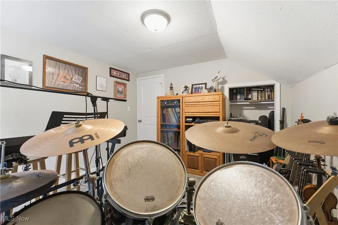 Playroom with vaulted ceiling and a textured ceiling