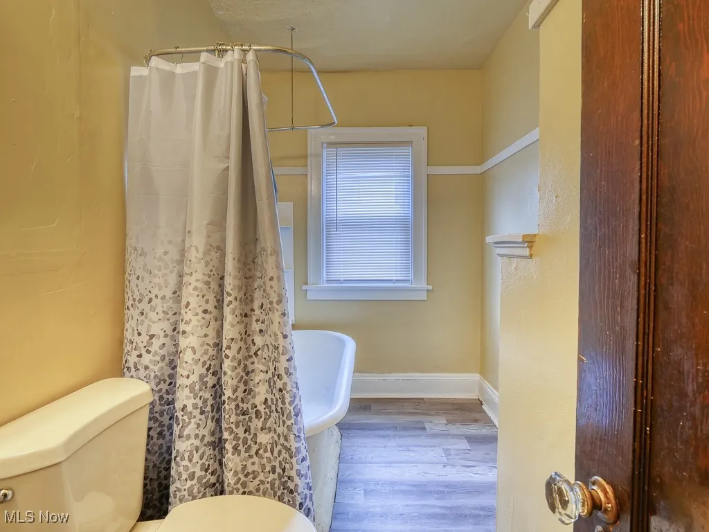 Full bathroom with curtained shower