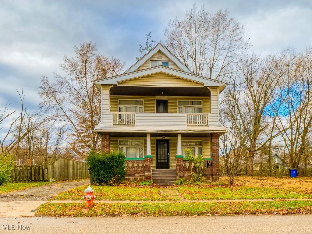 View of front of property featuring a porch and brick siding