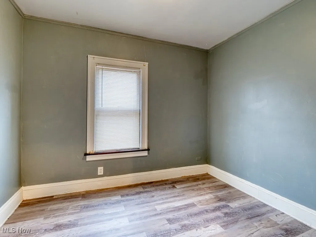 Spare room with light wood-style floors and baseboards