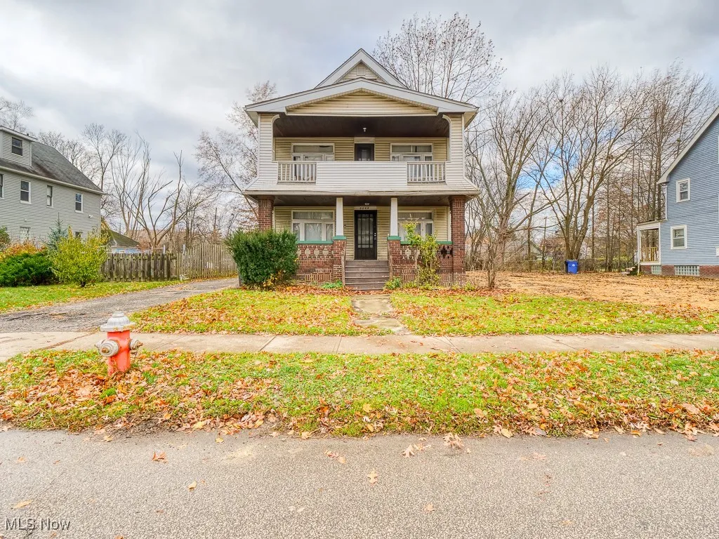 Traditional-style house with a porch and brick siding