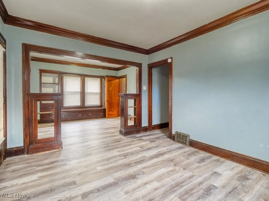 Living/Dining rooms featuring LVP floors and crown molding