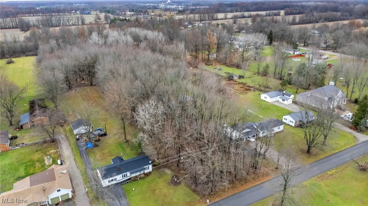 Aerial overview of property's location featuring nearby suburban area